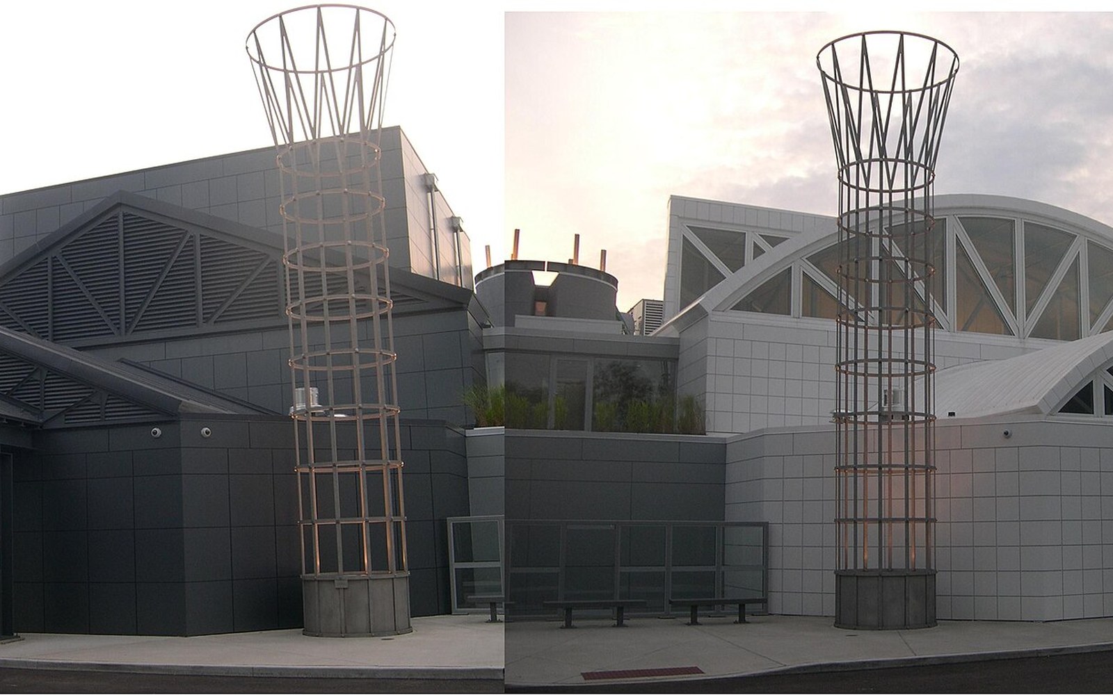 Tall wire-mesh sculptural columns stand outside the museum's angular concrete and glass facade